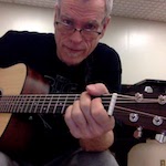 Steve Schalchlin playing acoustic guitar